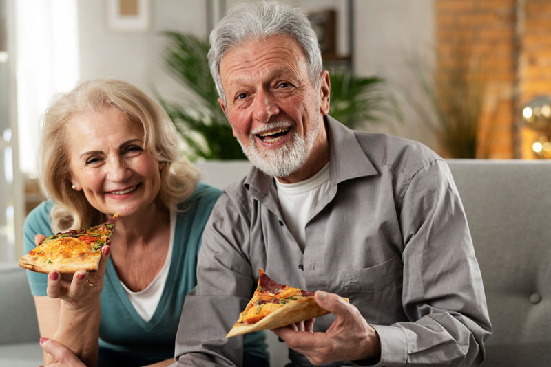 dental implant patients eating and smiling