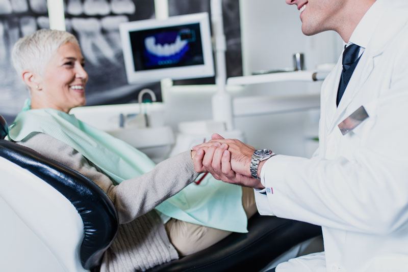 a patient smiling after her dental implants procedure