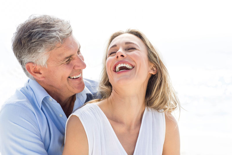 patients smiling after their dental implants procedure
