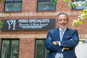 an image of Dr. Kharmouch standing in front of his dental practice.